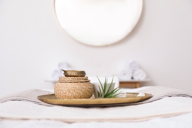 Photo of Beautiful spa composition on massage table in room