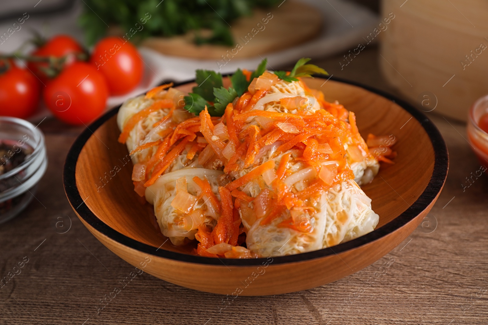 Photo of Delicious cabbage rolls on wooden table, closeup