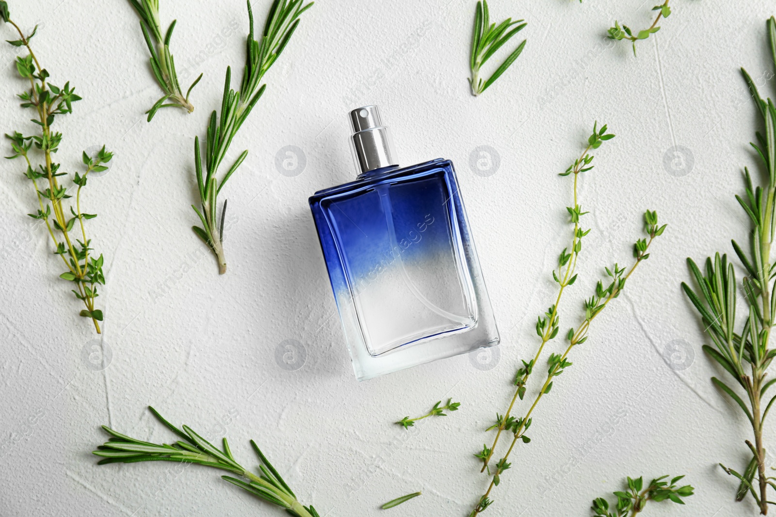 Photo of Beautiful composition with bottle of perfume on white background, flat lay