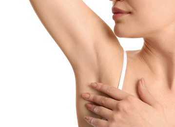 Young woman showing armpit with smooth clean skin on white background, closeup