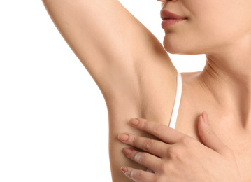 Photo of Young woman showing armpit with smooth clean skin on white background, closeup