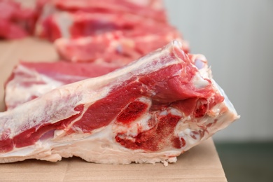 Photo of Pieces of fresh raw meat on counter in butcher shop