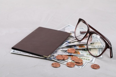 Photo of Pension certificate with American money and glasses on grey stone background