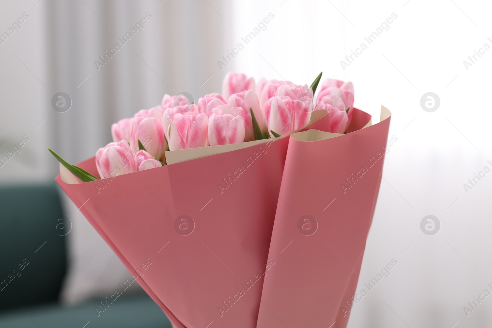 Photo of Beautiful bouquet of fresh pink tulips at home, closeup