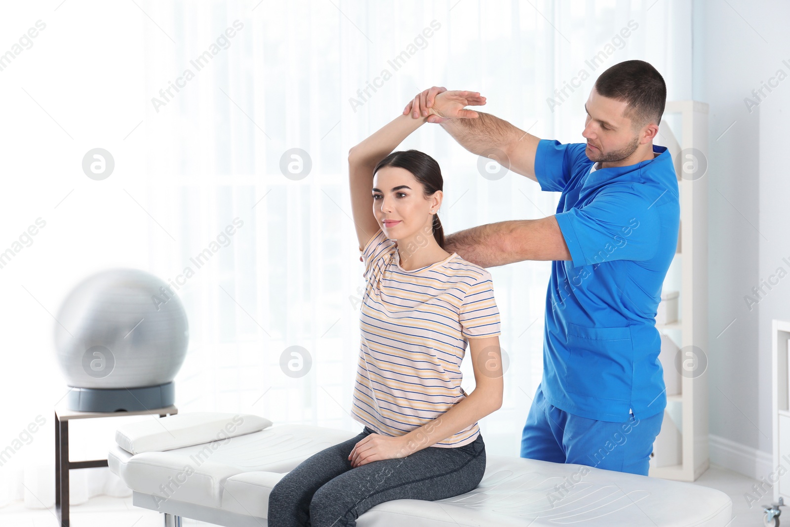 Photo of Doctor working with patient in hospital. Rehabilitation physiotherapy