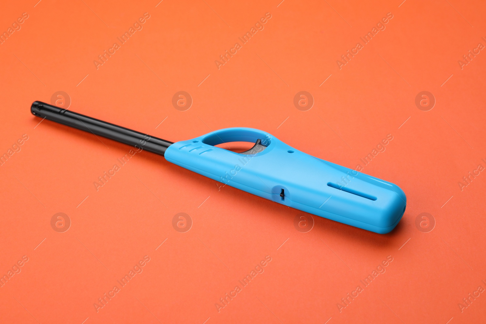 Photo of One blue gas lighter on orange background