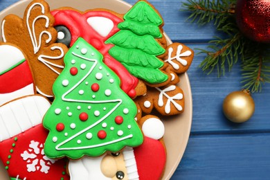Different tasty Christmas cookies and decor on blue wooden table, flat lay