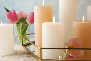 Composition with burning candles on table, closeup