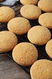 Photo of Many tasty sugar cookies on wooden table, closeup