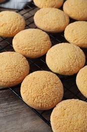 Many tasty sugar cookies on wooden table, closeup