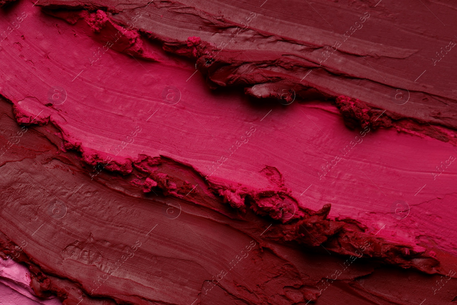 Photo of Texture of beautiful lipsticks as background, top view