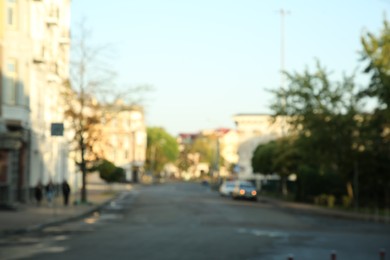 Blurred view of quiet city street with buildings along road