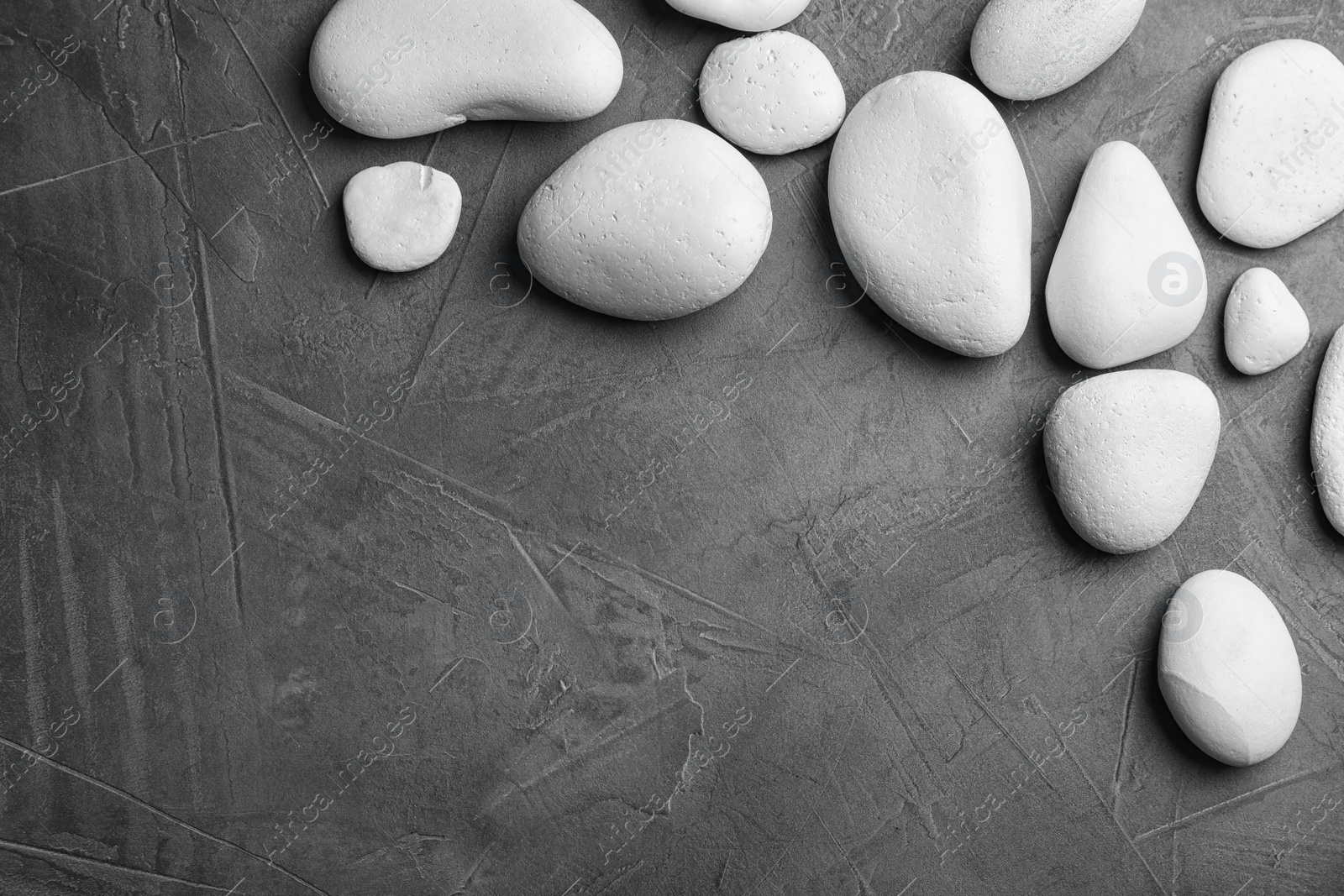 Photo of Zen stones on dark background, top view with space for text