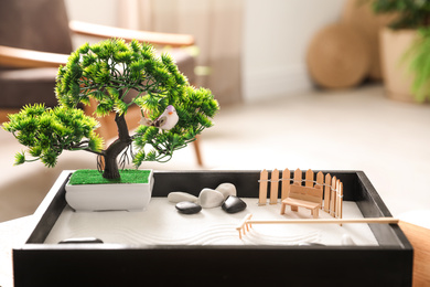 Beautiful miniature zen garden on wooden table indoors