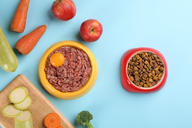 Photo of Pet food and natural ingredients on light blue background, flat lay