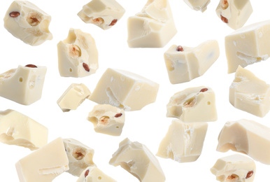 Image of Delicious chocolate chunks falling on white background