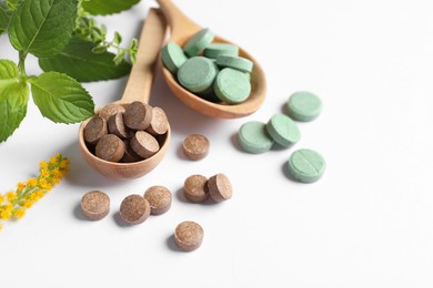 Photo of Different pills and herbs on white background, closeup. Dietary supplements