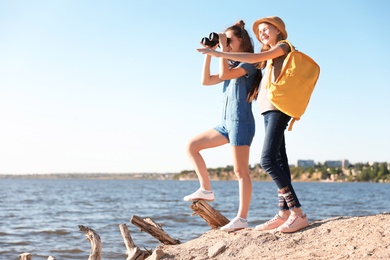 Photo of Teenage girls with binoculars on beach. Summer camp