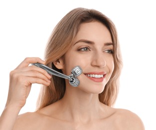 Photo of Young woman using metal face roller on white background