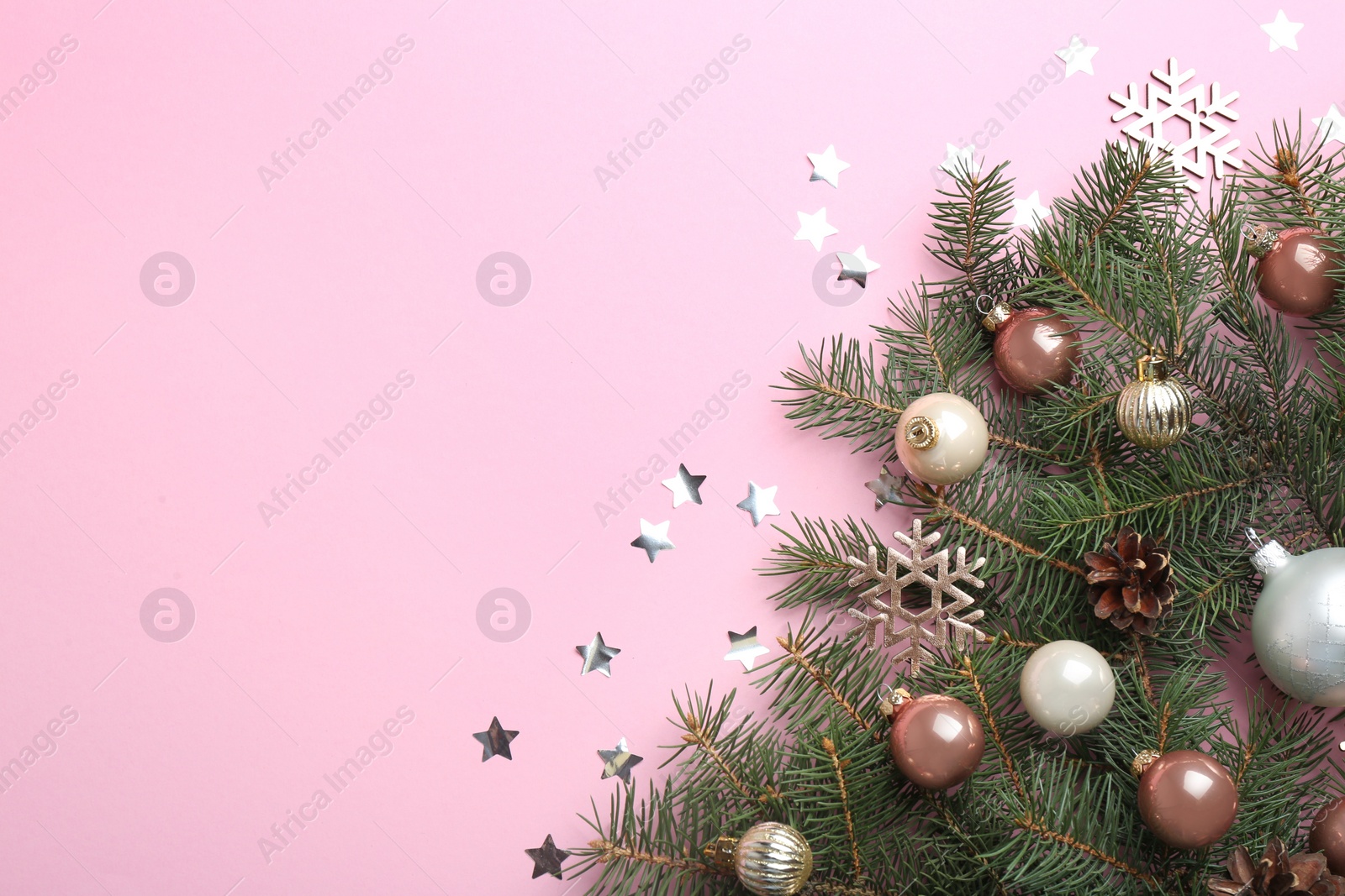 Photo of Flat lay composition with Christmas decor on light pink background. Space for text