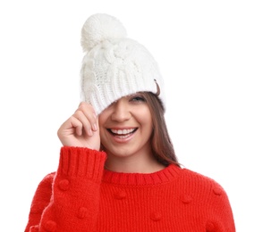 Young woman in warm sweater and hat on white background. Winter season
