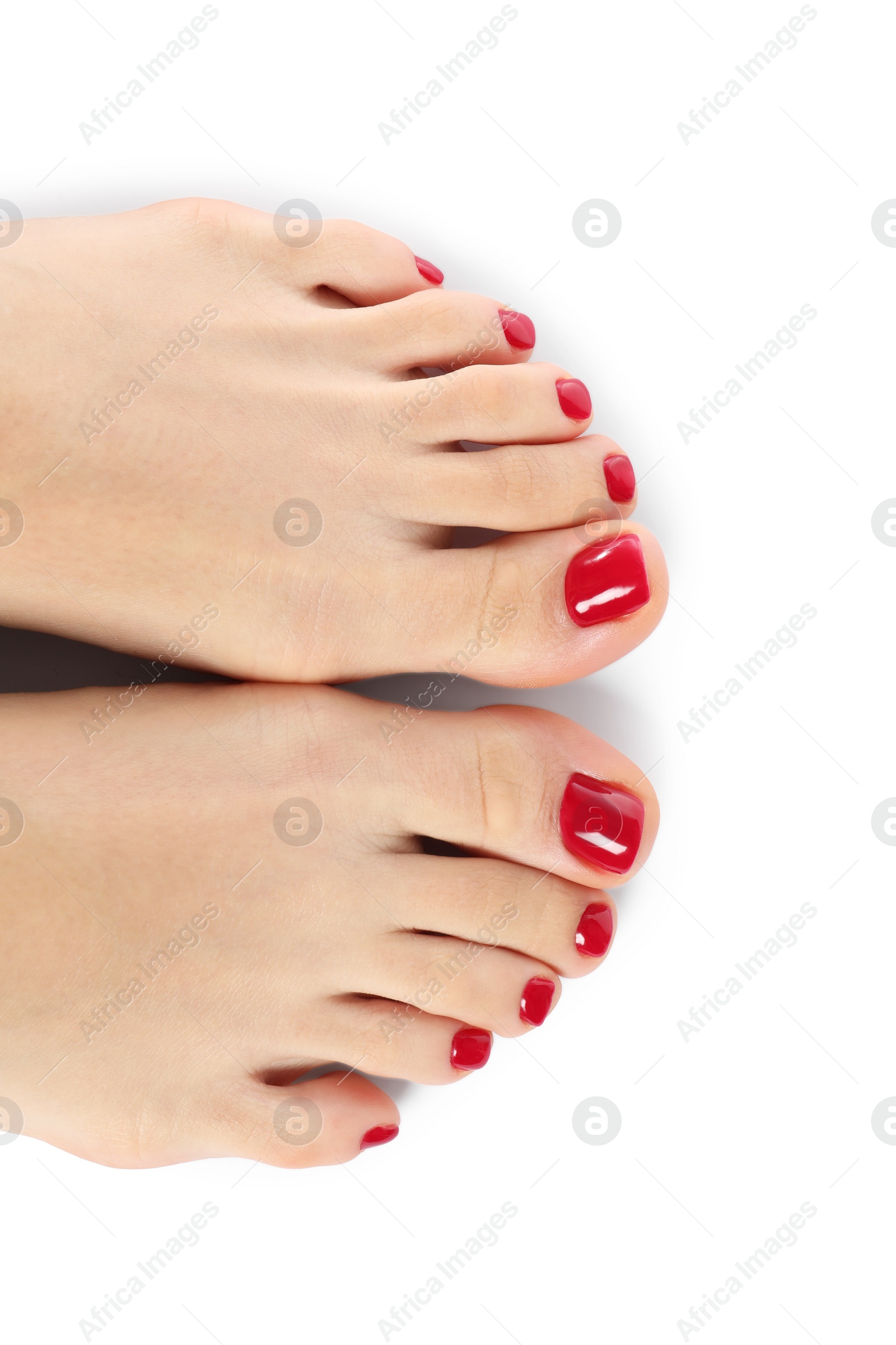 Photo of Woman with stylish red toenails after pedicure procedure isolated on white, top view