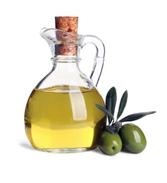 Photo of Glass jug of oil, ripe olives and leaves on white background