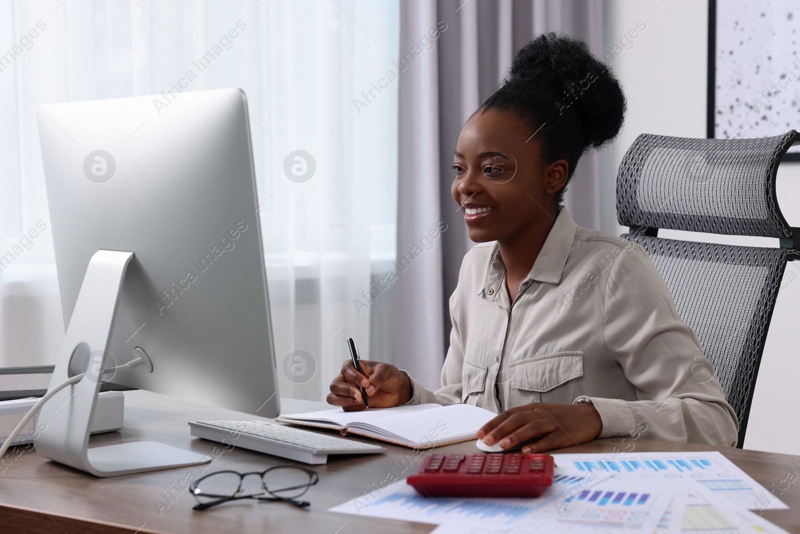 Photo of Professional accountant working on computer at wooden desk in office