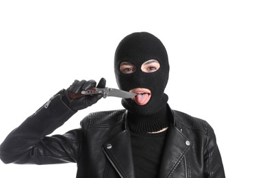 Photo of Woman wearing knitted balaclava with knife on white background