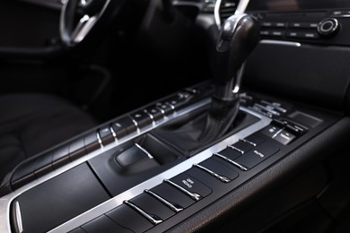 Gear stick inside of modern black car, closeup