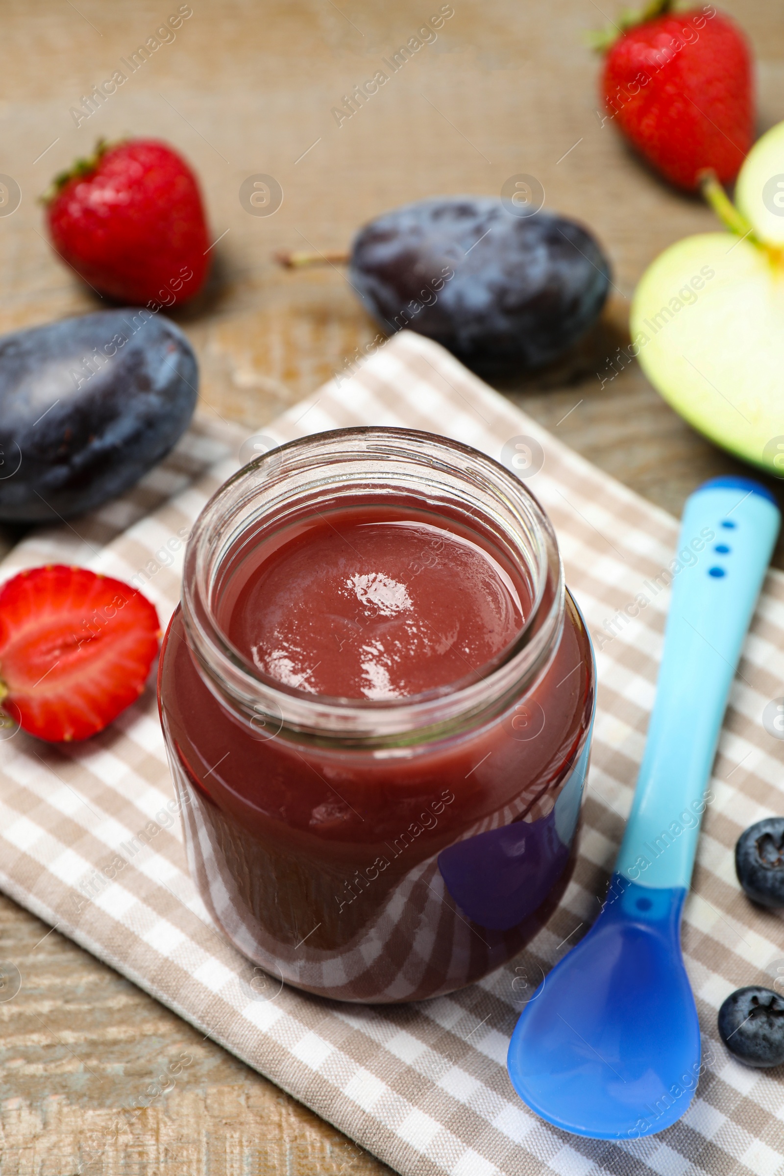 Photo of Healthy baby food and fresh ingredients on wooden table