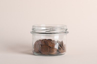 Photo of Glass jar with coins on white background, closeup