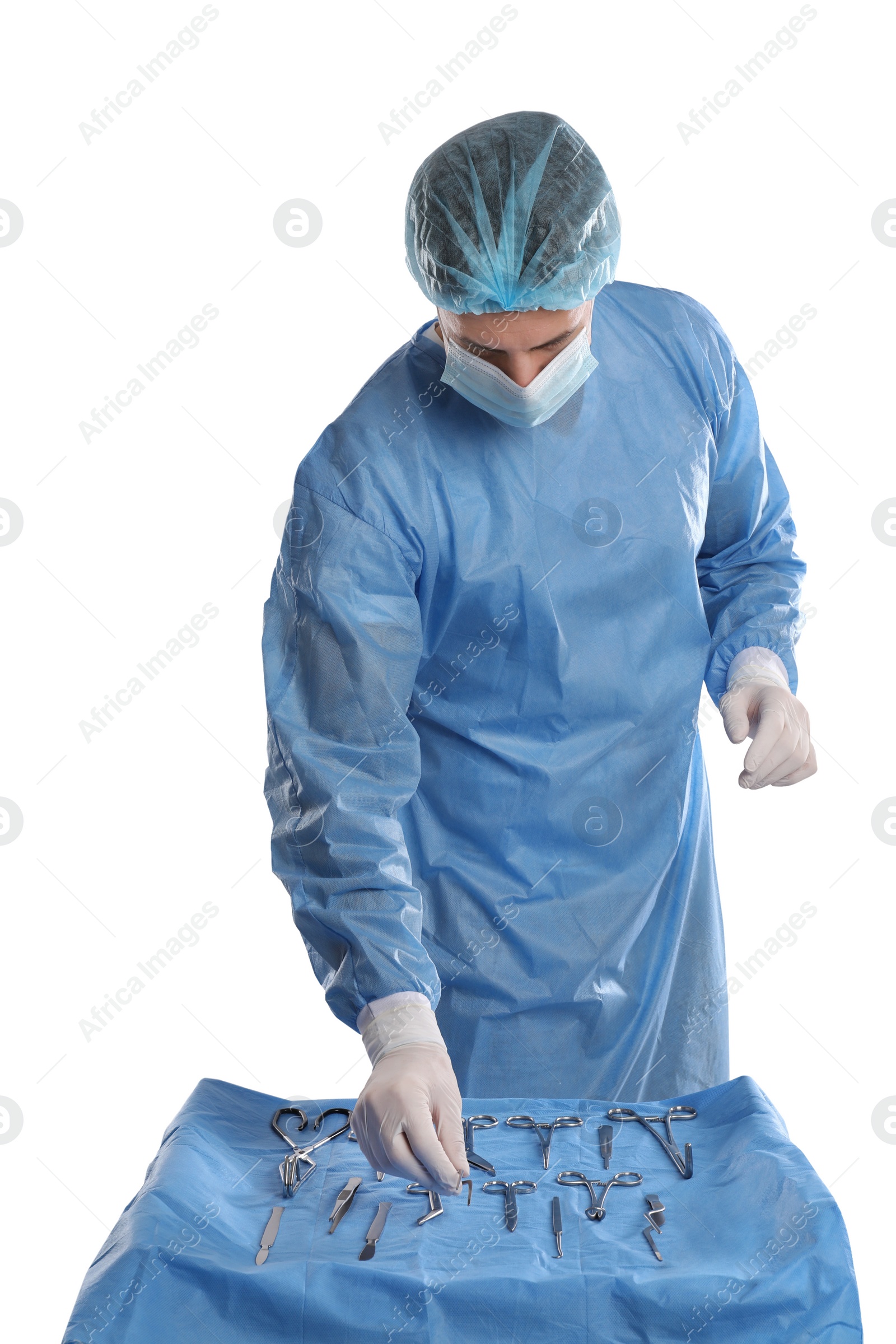 Photo of Doctor taking surgical instrument from table on light background