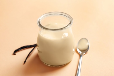 Photo of Vanilla pudding and sticks on color background