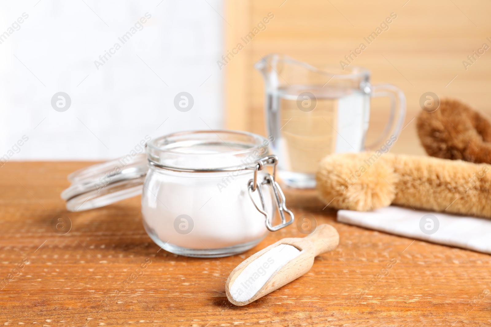 Photo of Baking soda on wooden table. Natural detergent