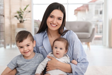 Photo of Happy mother with her cute children at home. Family time