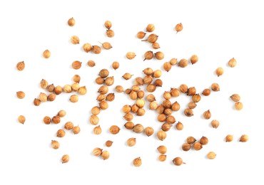 Photo of Scattered dried coriander seeds on white background, top view