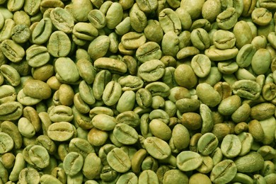 Photo of Many green coffee beans as background, top view