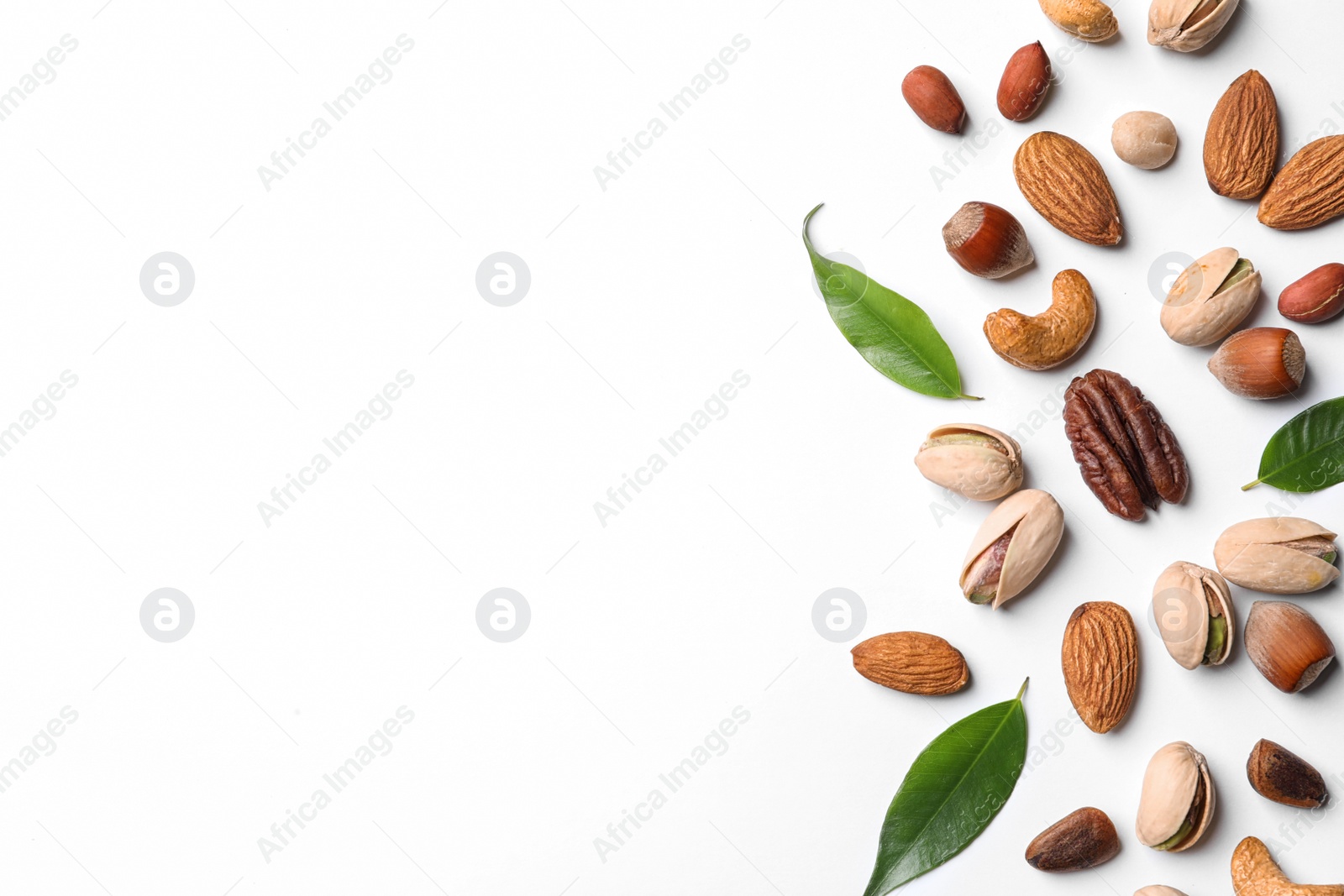 Photo of Composition with organic mixed nuts on white background, top view. Space for text