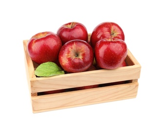 Photo of Wooden crate of ripe juicy red apples with leaf on white background