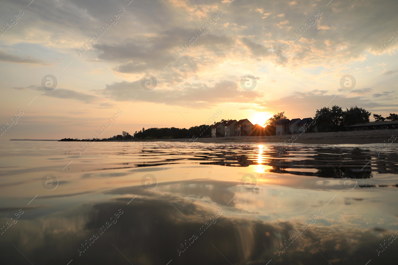 Photo of Picturesque view of sea and coast at sunset