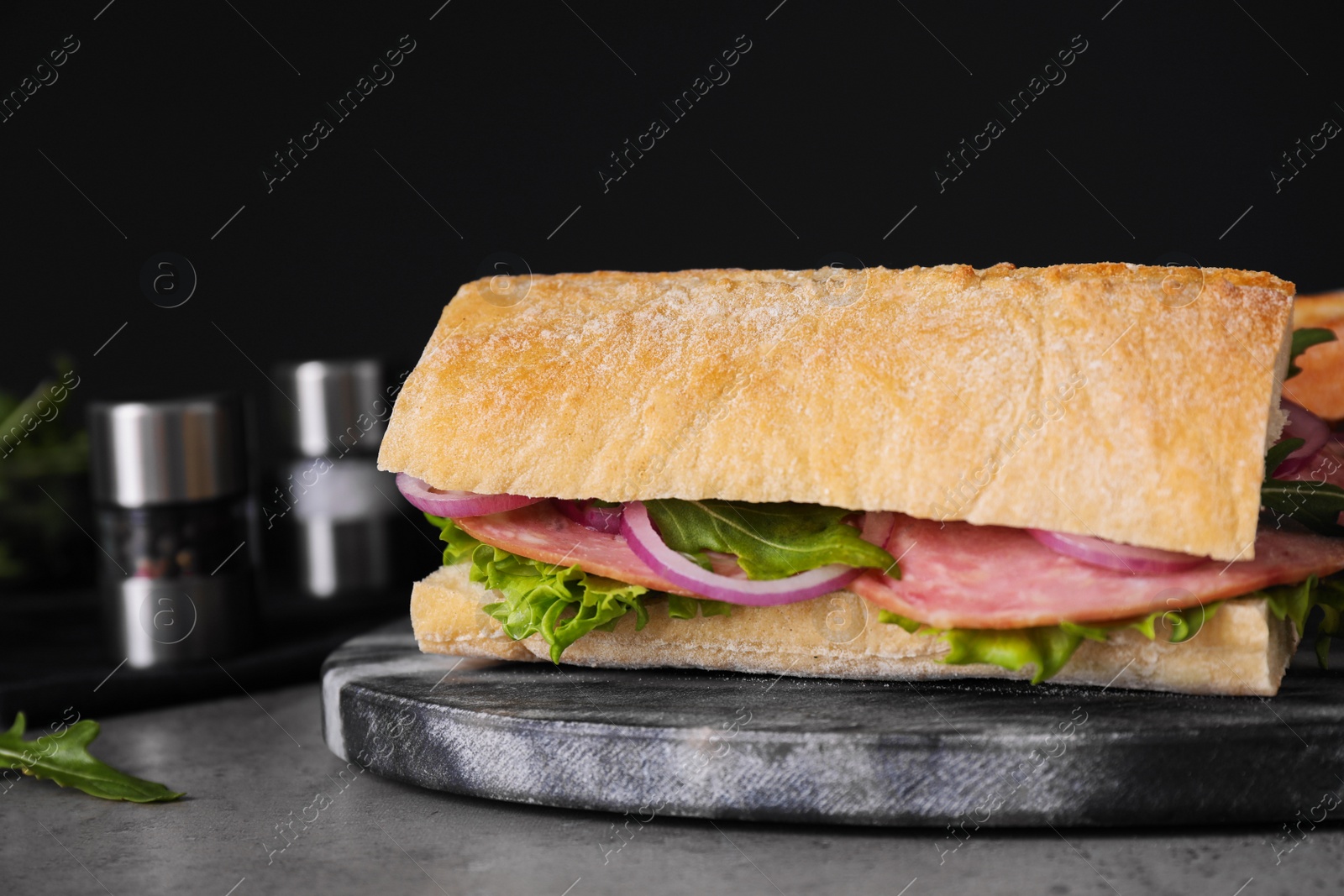 Photo of Tasty sandwich with ham on grey table, closeup