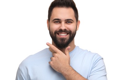 Photo of Man showing his clean teeth and smiling on white background