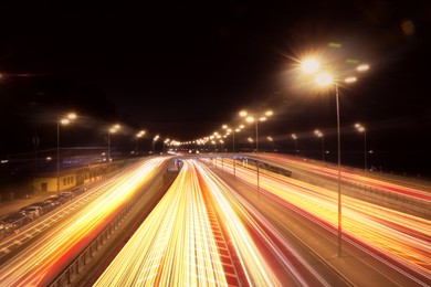 Image of Road traffic, motion blur effect. View of car light trails at night