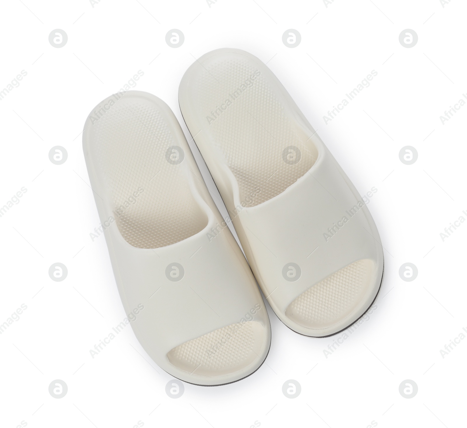 Photo of Pair of rubber slippers isolated on white, top view