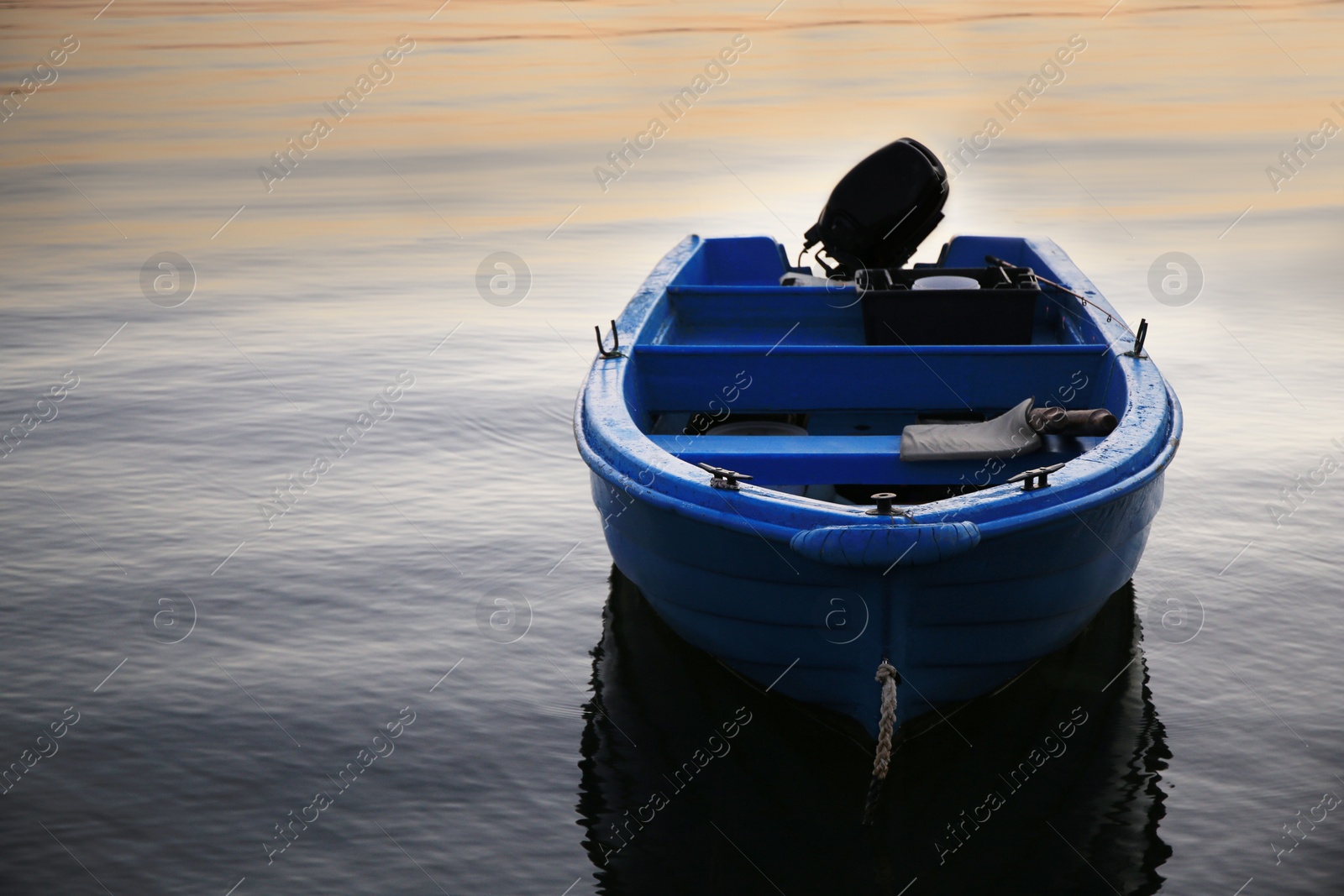 Photo of Beautiful view of river with moored boat at sunset