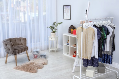 Photo of Dressing room interior with stylish clothes and shoes