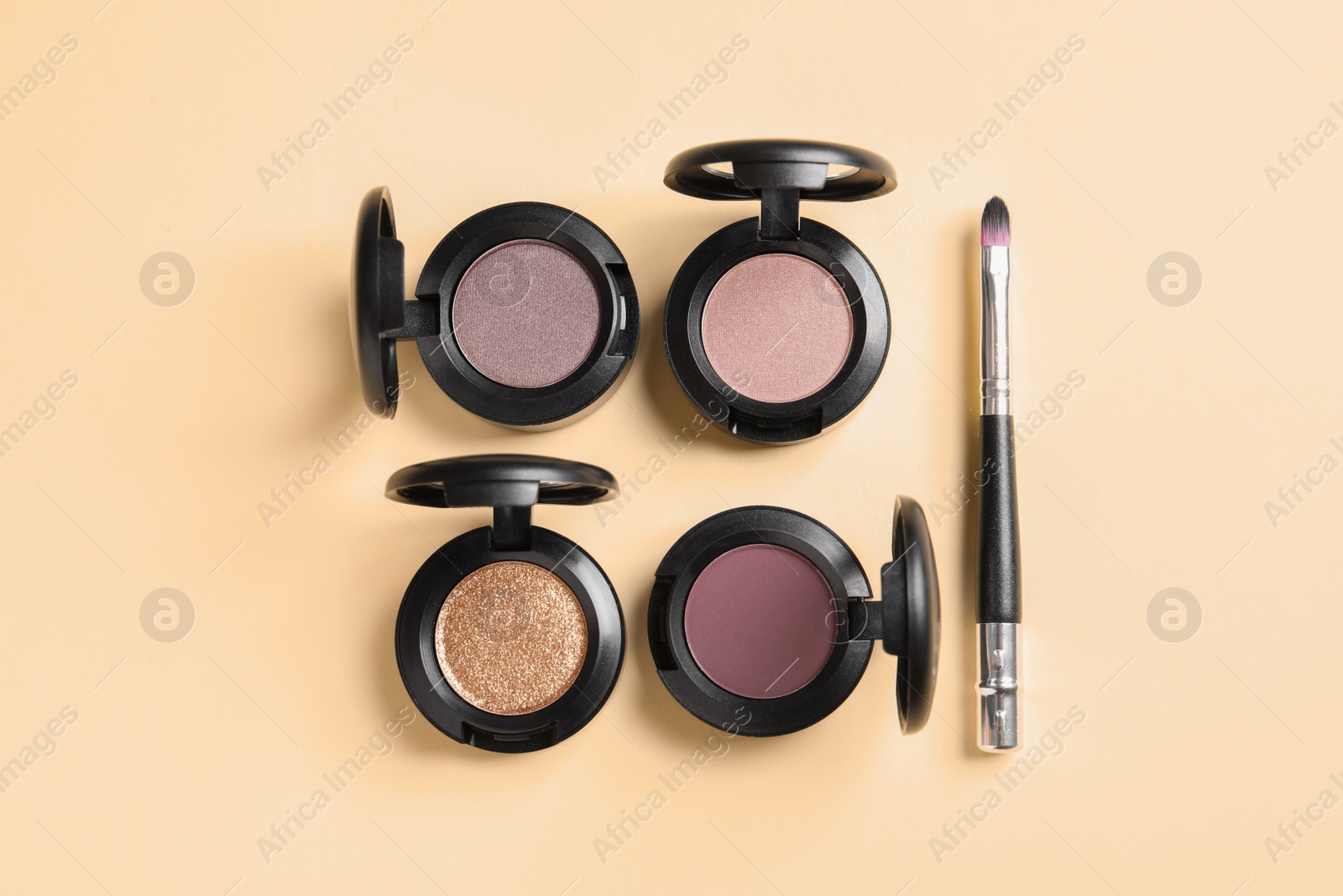 Photo of Flat lay composition with different eye shadows on color background