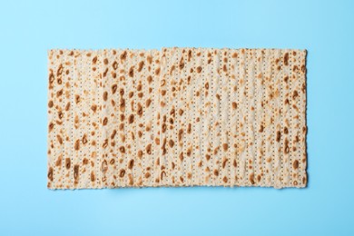 Photo of Traditional matzos on light blue background, top view