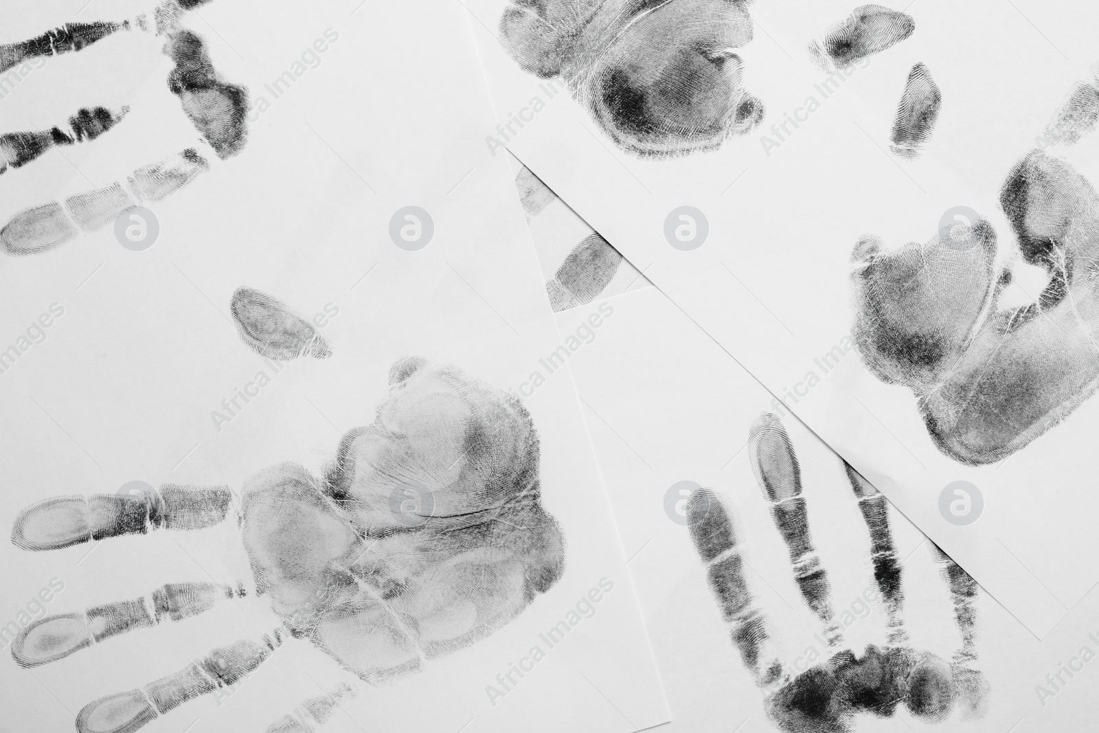 Photo of Print of hands and fingers on white background, top view. Criminal investigation